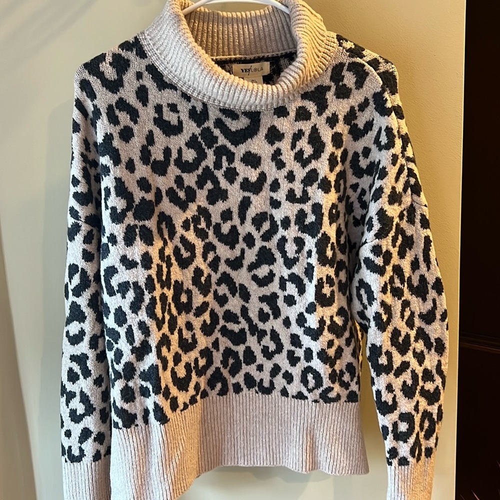 Fashionable cheetah sweater in tan and black. Never worn. Nice and cozy